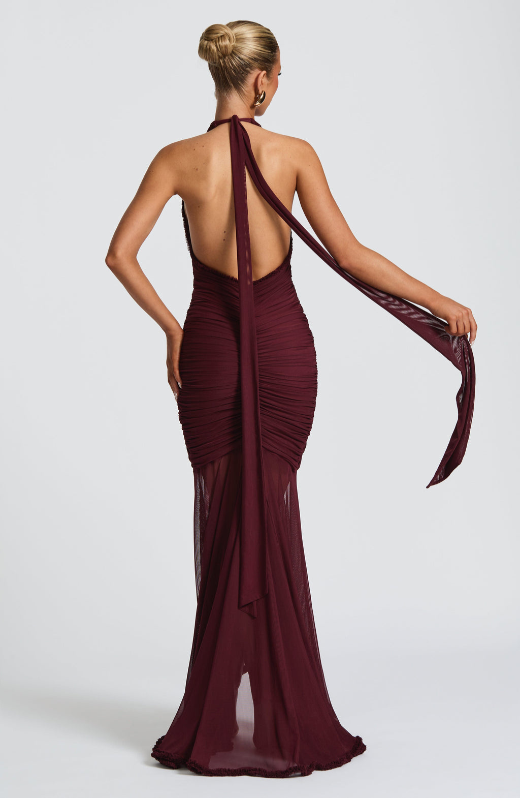 Back view of cherry red mesh halter maxi dress with tie streamers