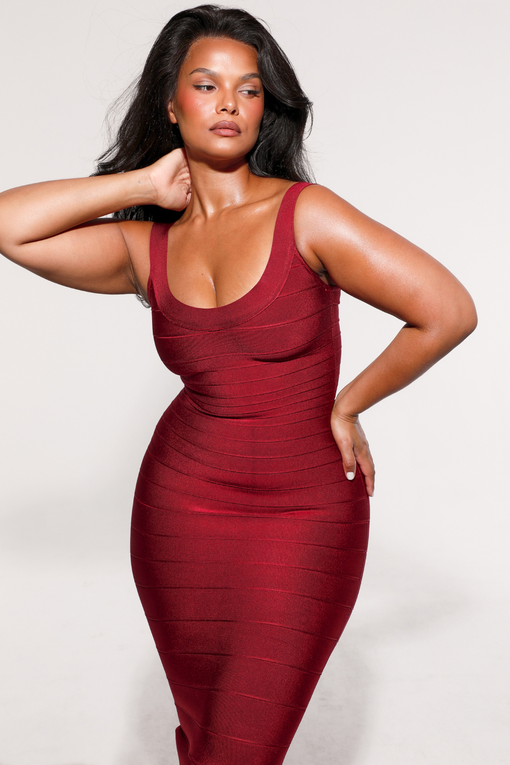 Ruby red bandage maxi dress, close-up front view, hand behind neck