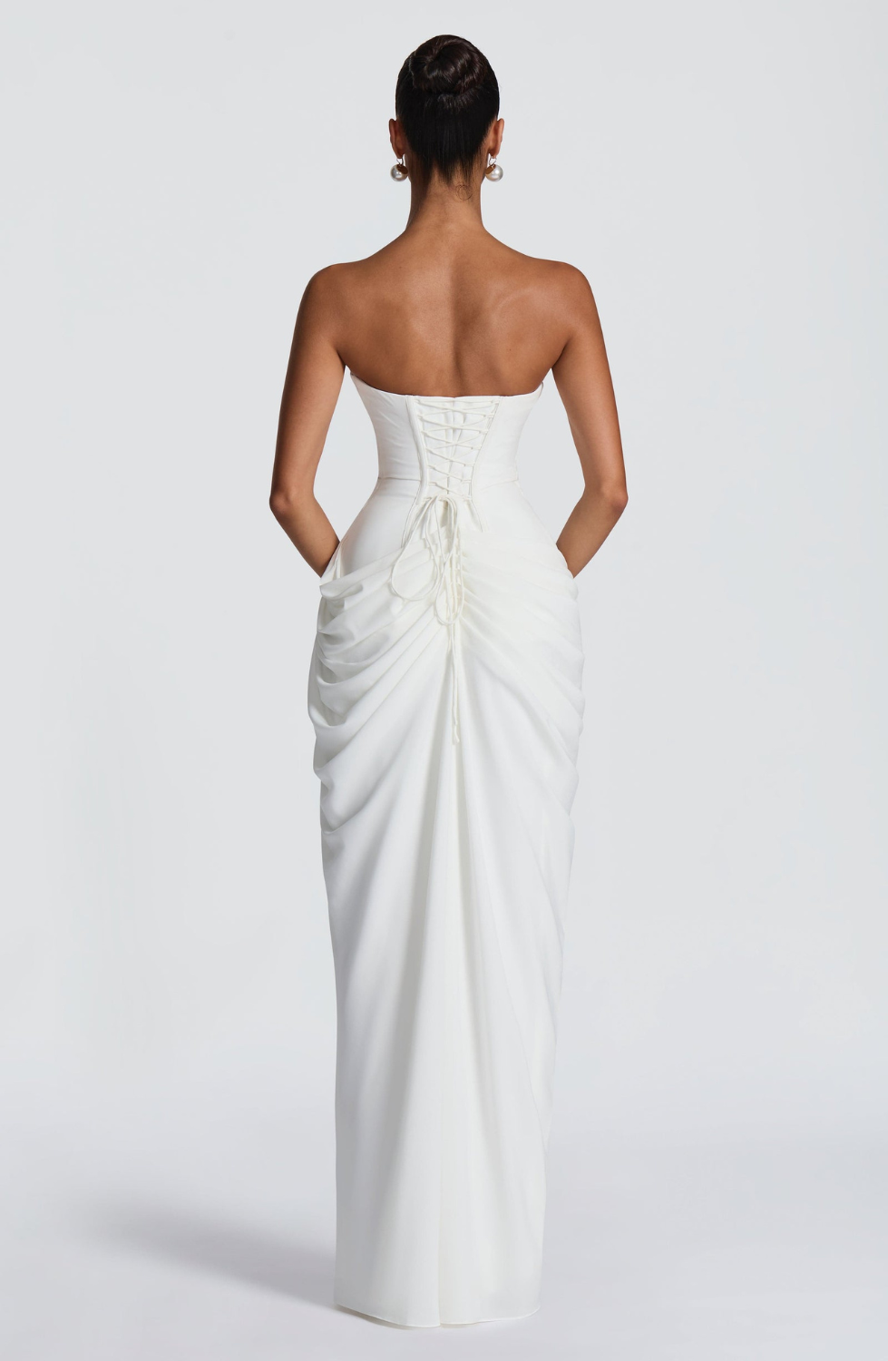 Ivory strapless maxi dress with corset lace-up back, back view on model