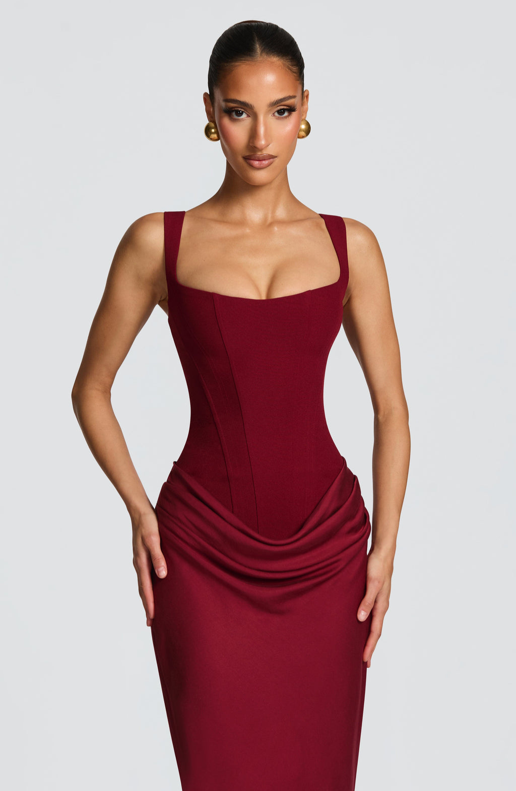 Close-up of burgundy corset dress square neckline on model