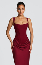 Close-up of burgundy corset dress square neckline on model