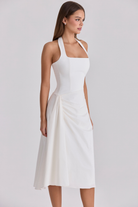 Ivory halter-neck midi dress, three-quarter side view on model