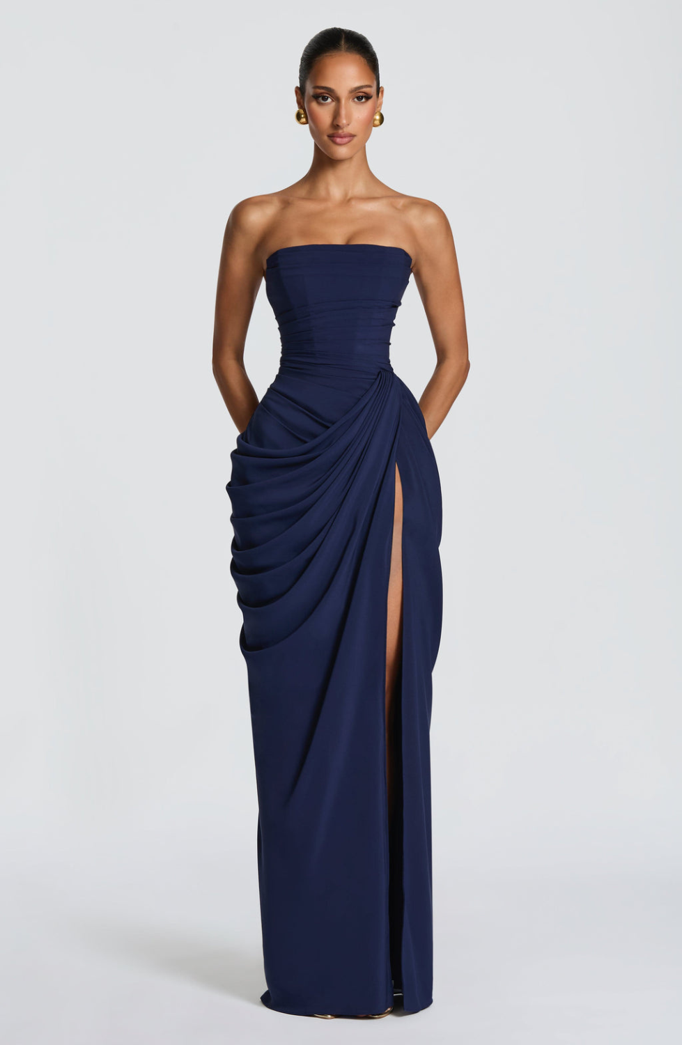 Navy strapless maxi dress with draped skirt, close front view on model