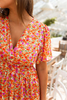 Close-up of the floral print wrap bodice on the maxi dress