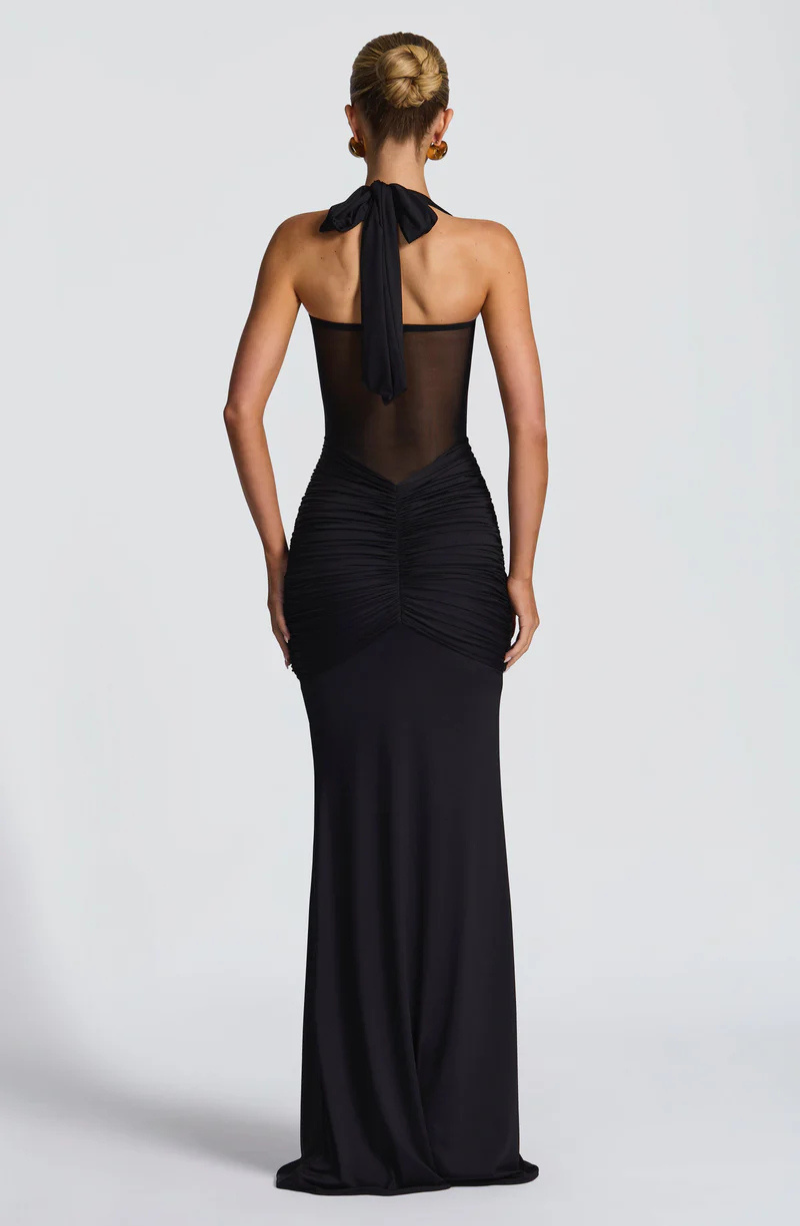 Black halter neck maxi dress with bow tie neck, back view on model