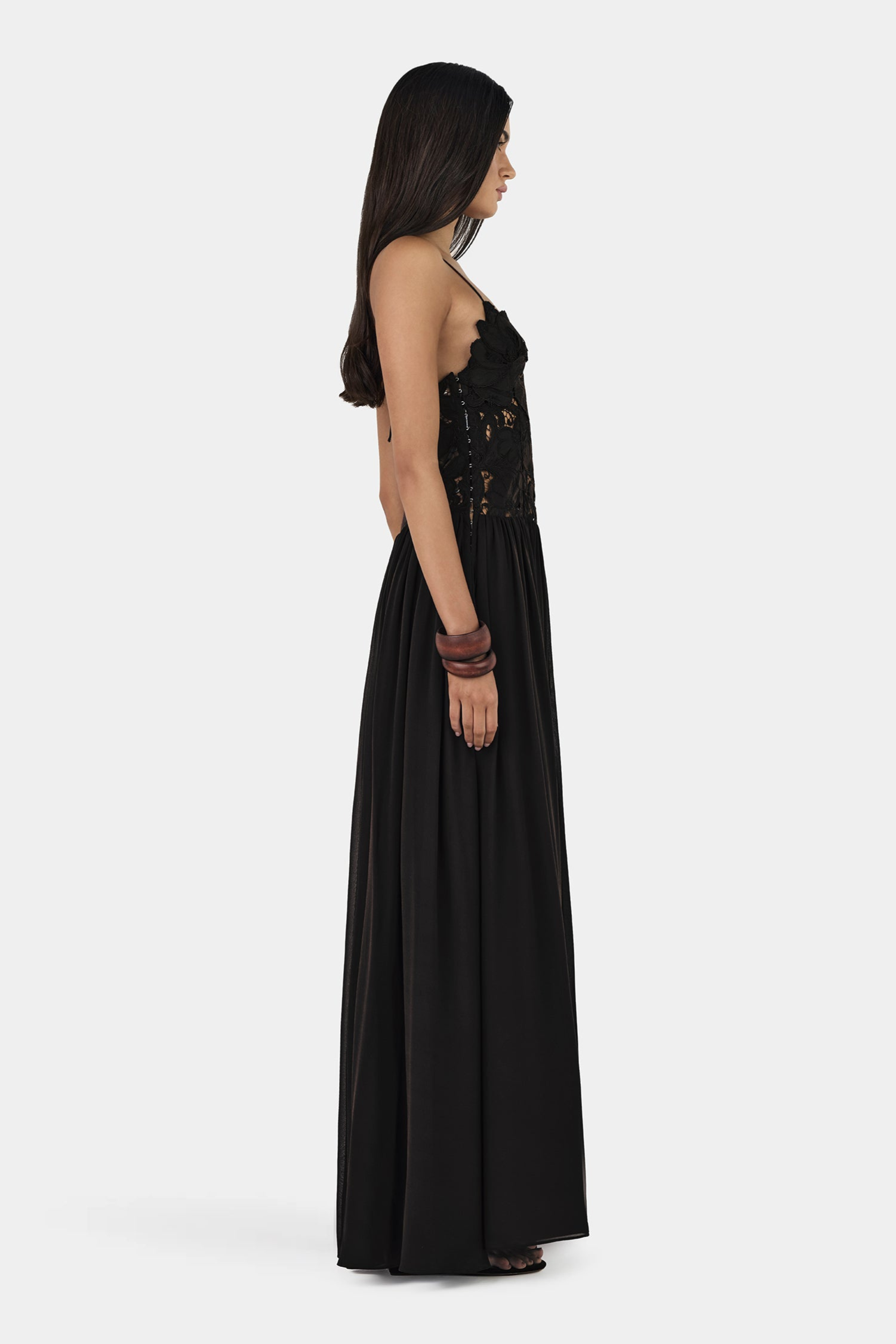 Black lace maxi dress, side profile view on model