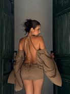 Taupe backless mini dress with beaded chain detail, back view on model