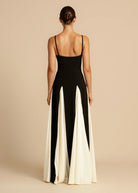 Black maxi dress with ivory godets, back view on model