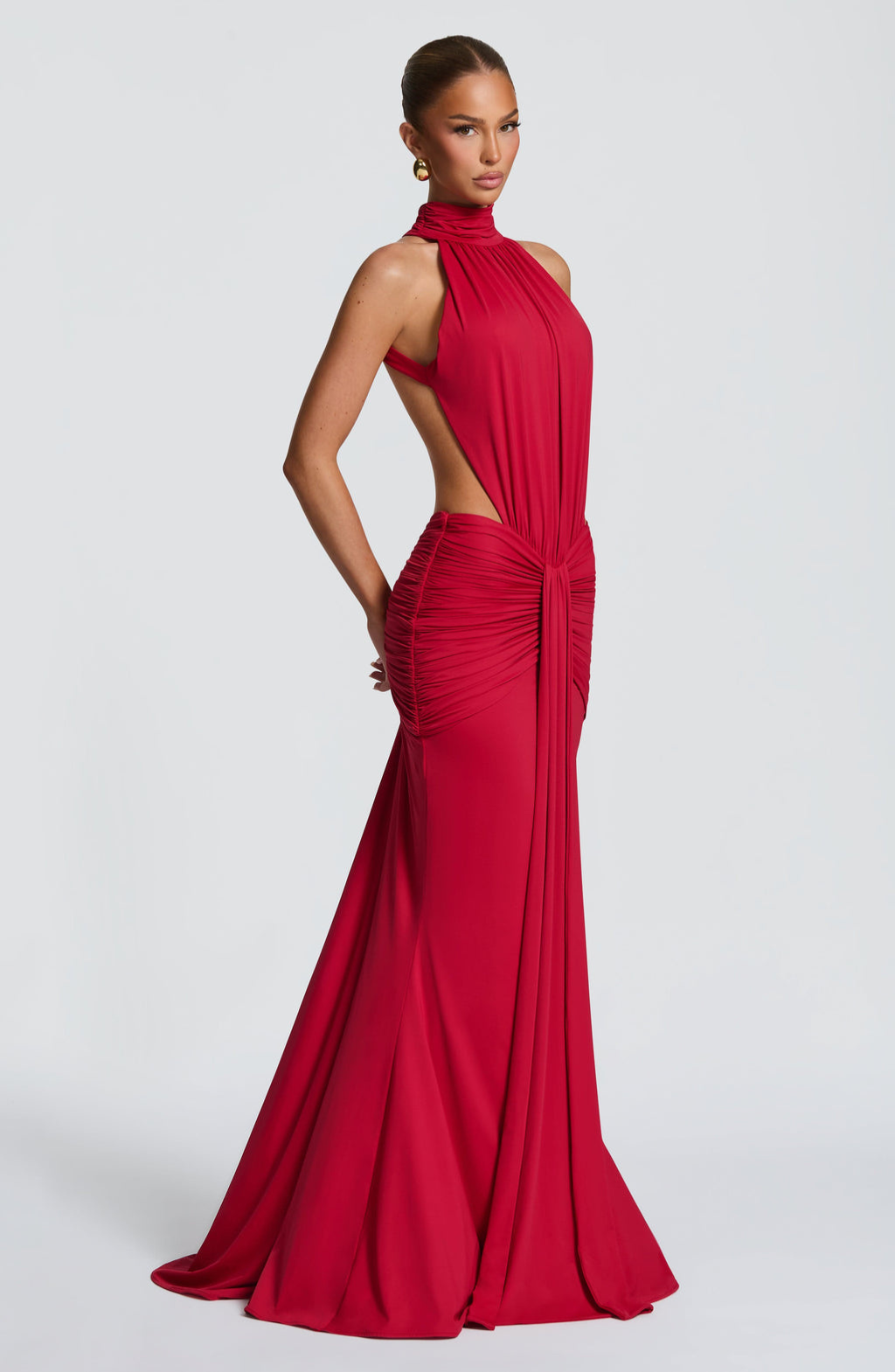 Red halter maxi dress with side cutout, profile view on model