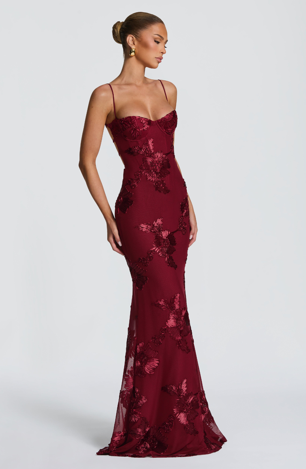 Burgundy fitted maxi dress with floral lace embroidery, side view on model