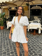 White textured puff-sleeve mini dress, straight-on view on model
