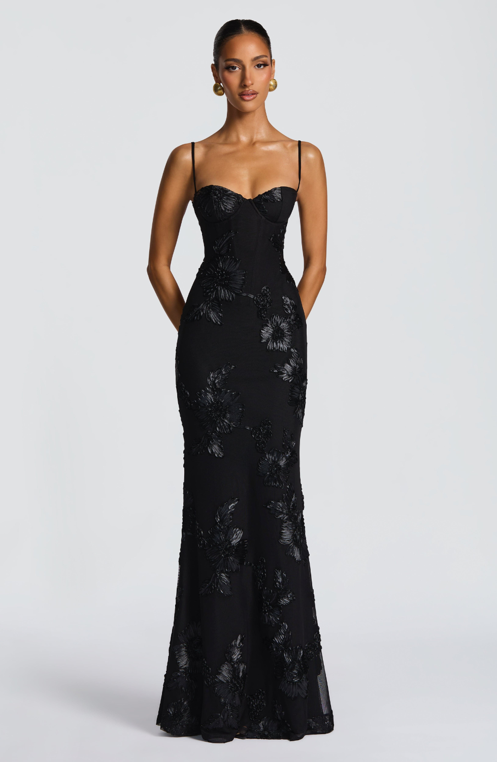 Black fitted maxi dress with corset bodice, close front view on model