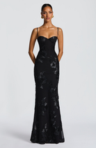 Black fitted maxi dress with corset bodice, close front view on model
