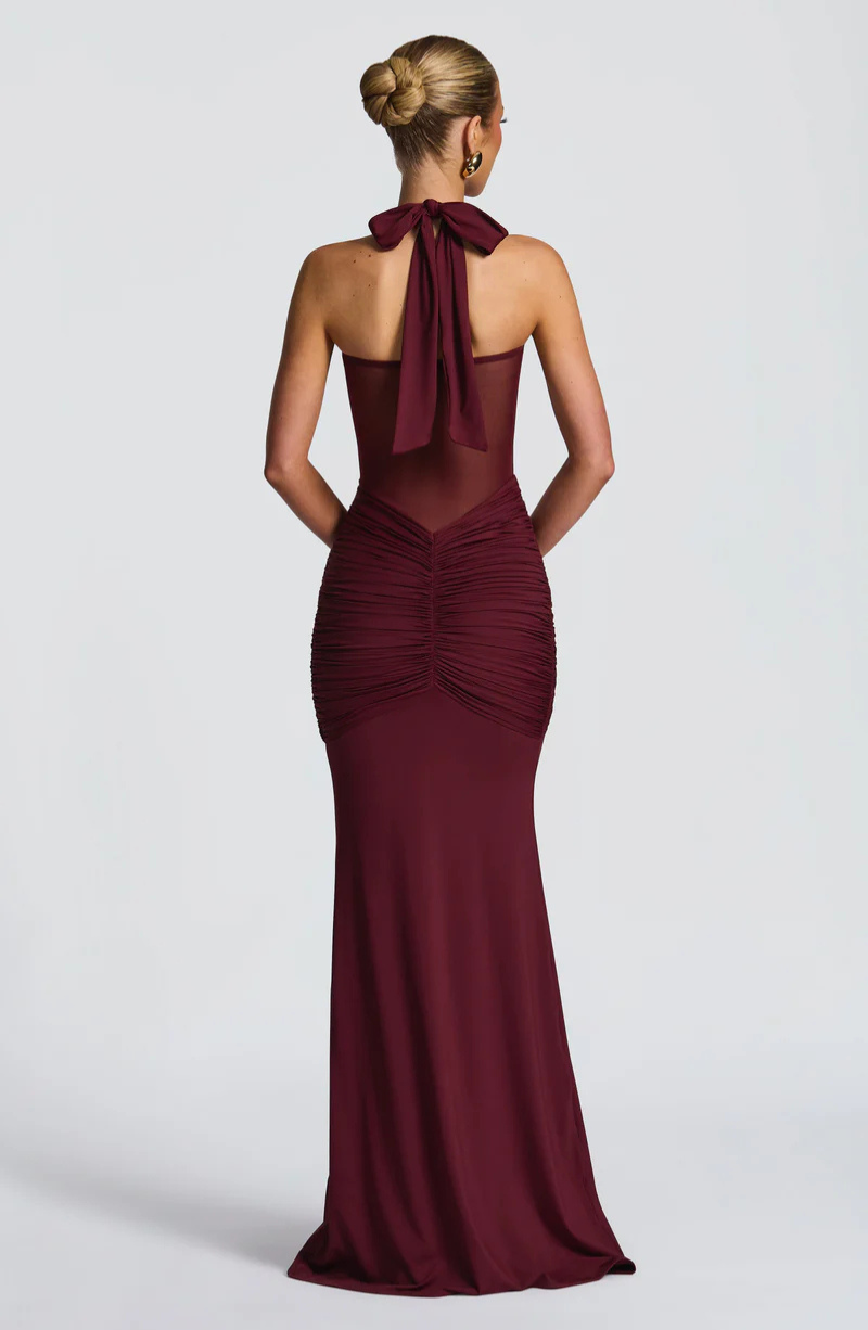 Wine halter neck maxi dress with bow tie neck, back view on model