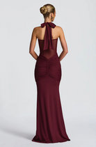 Wine halter neck maxi dress with bow tie neck, back view on model
