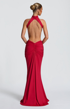 Red backless maxi dress with halter neck, back view on model