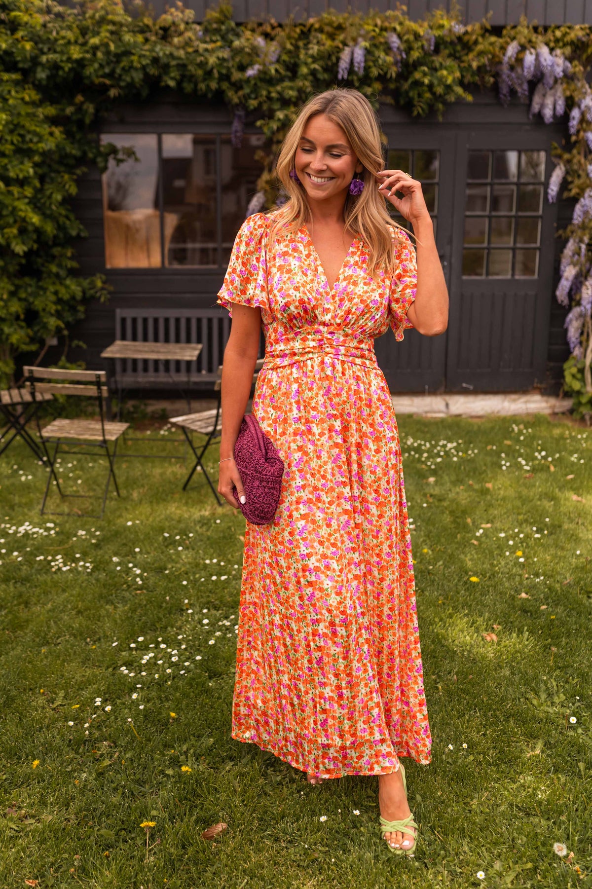 Orange floral print maxi dress with wrap neckline, front view on model