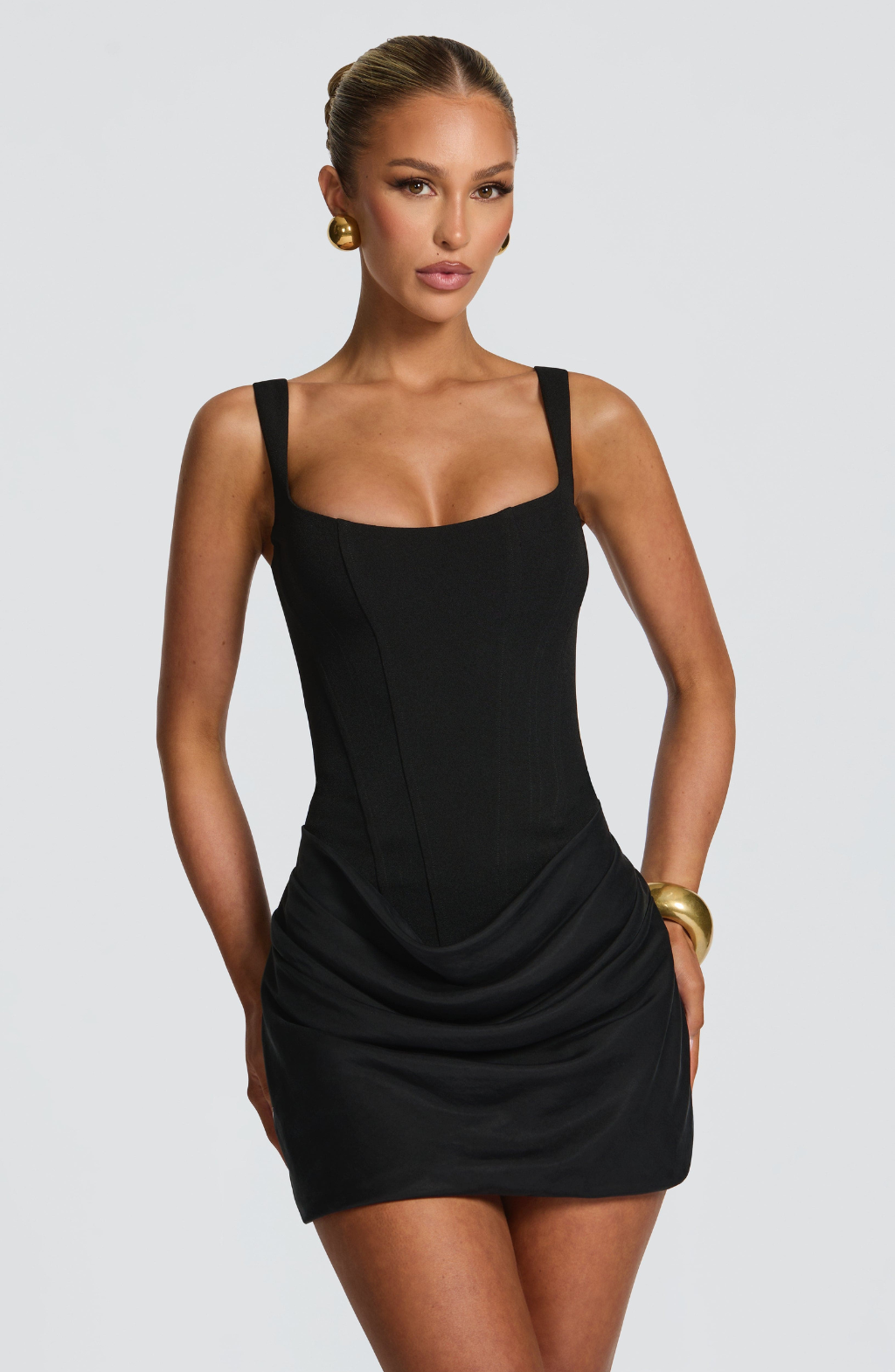 Black corset mini dress with ruched skirt, front view on model