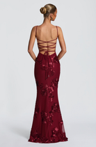 Burgundy fitted maxi dress with lace-up open back, back view on model