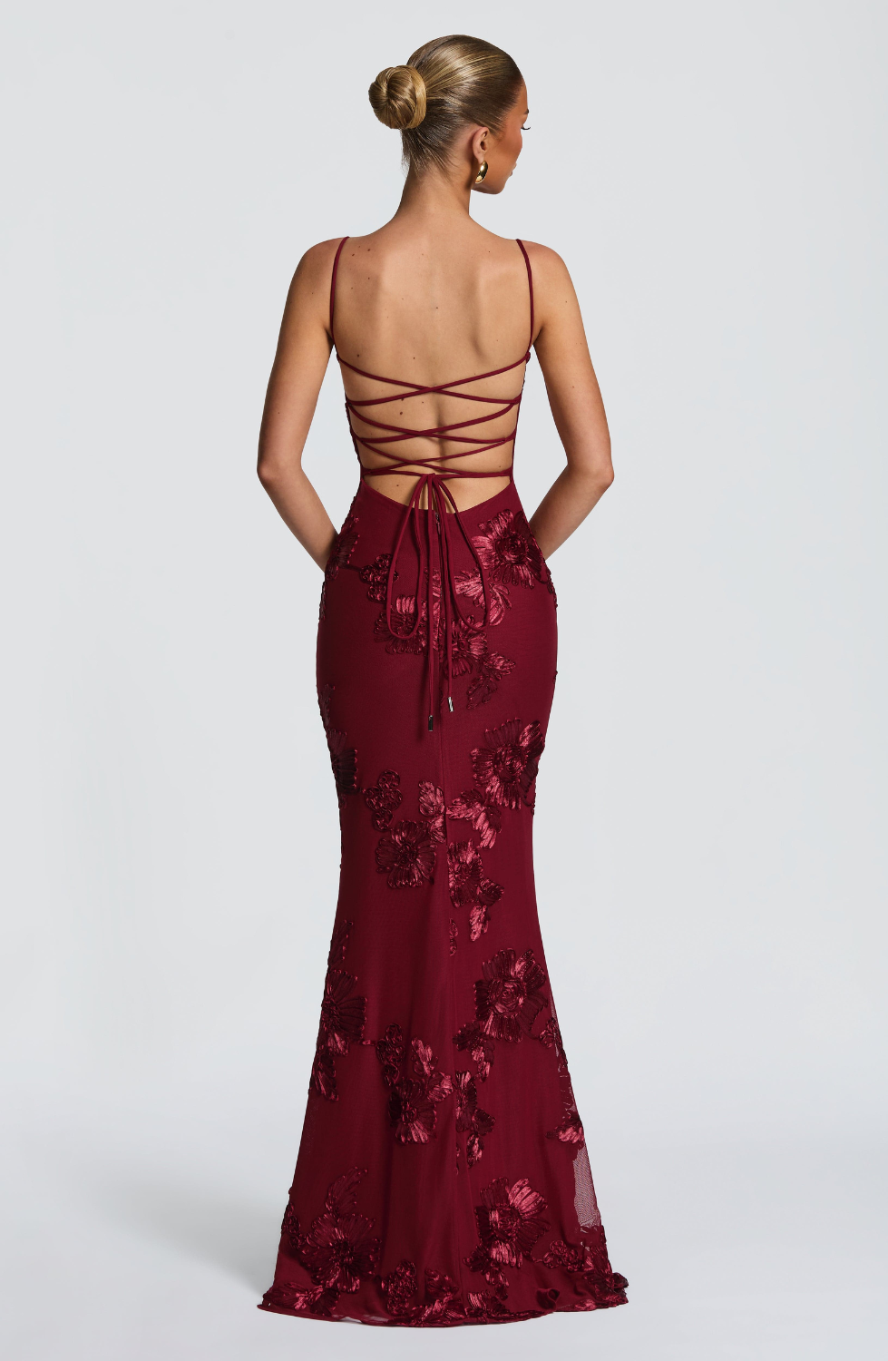 Burgundy fitted maxi dress with lace-up open back, back view on model