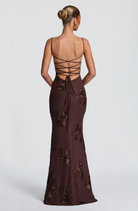 Mocha brown fitted maxi dress with lace-up open back, back view on model