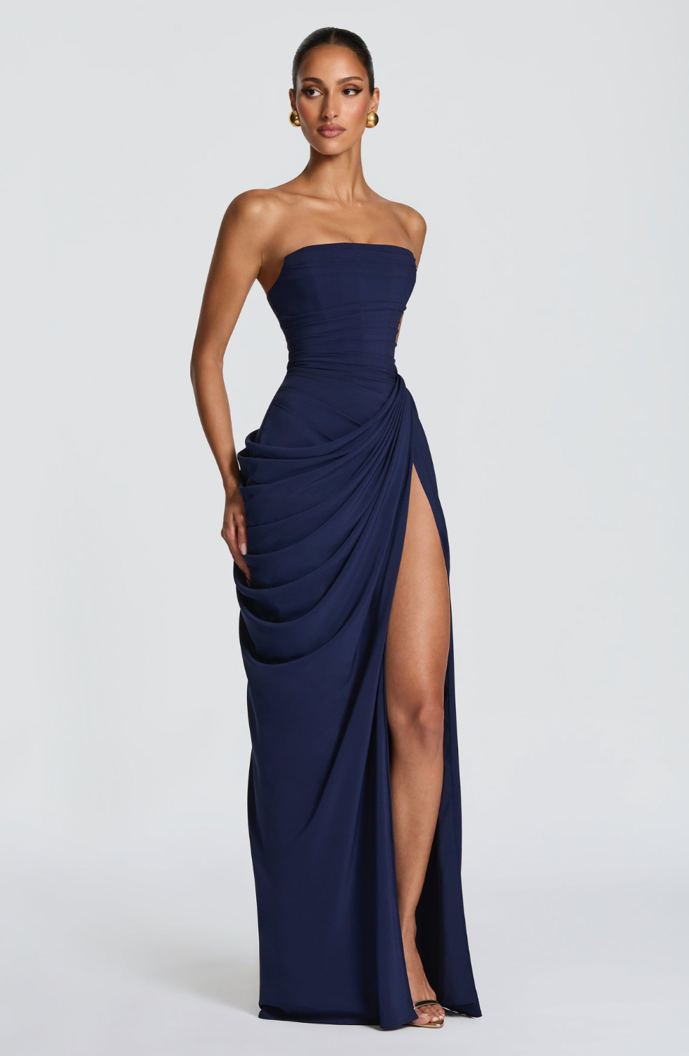 Navy strapless maxi dress with thigh-high split, side view on model
