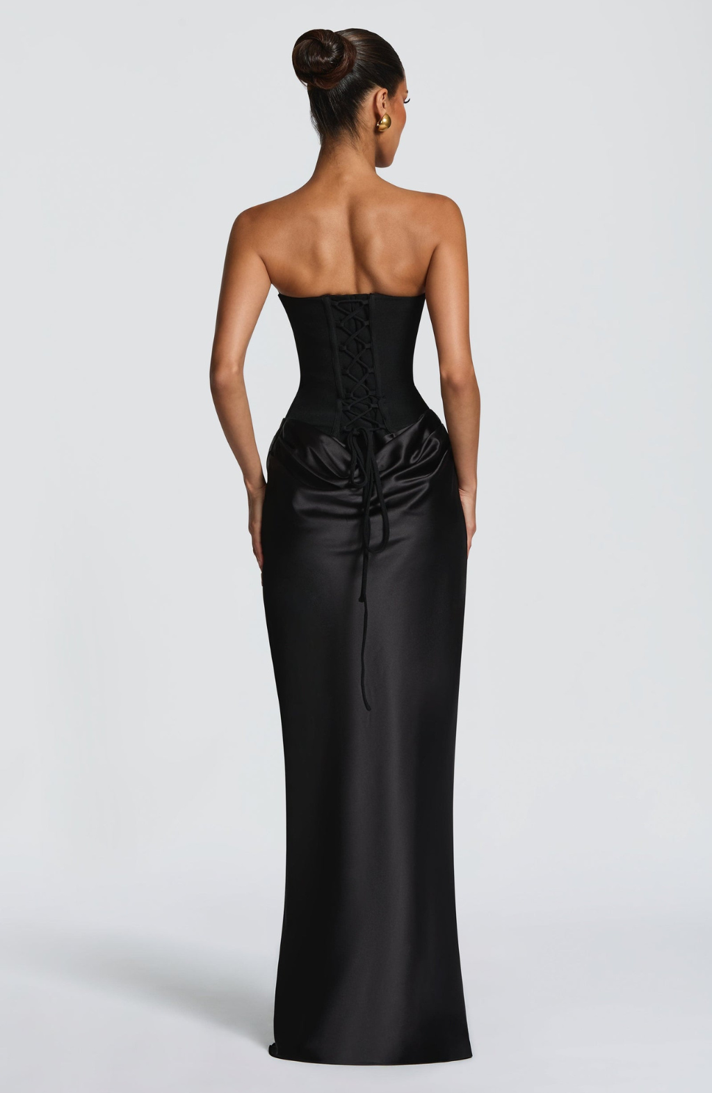 Back view of black satin maxi dress showing lace-up corset back