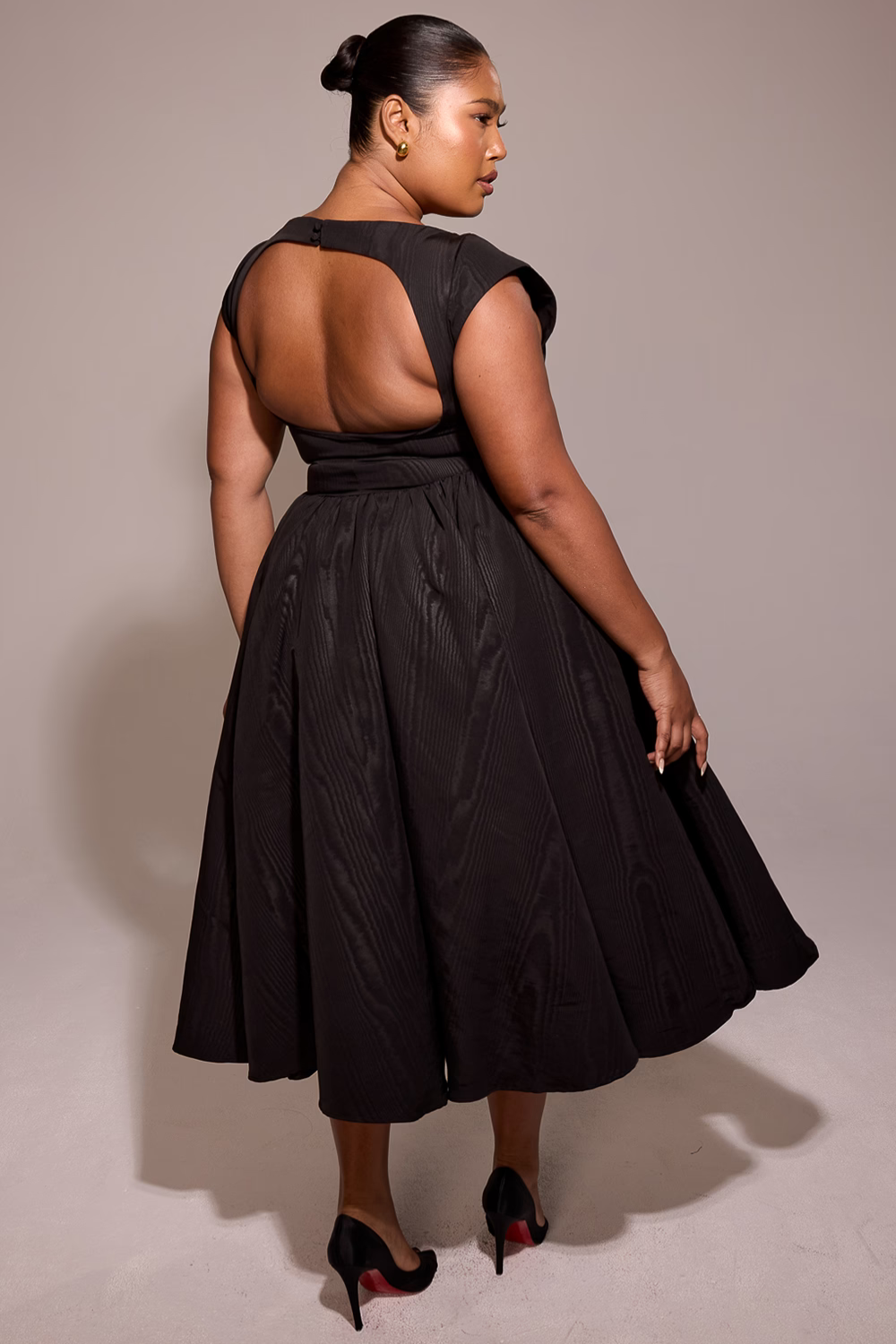 Black full-skirt midi dress, back view showing open back