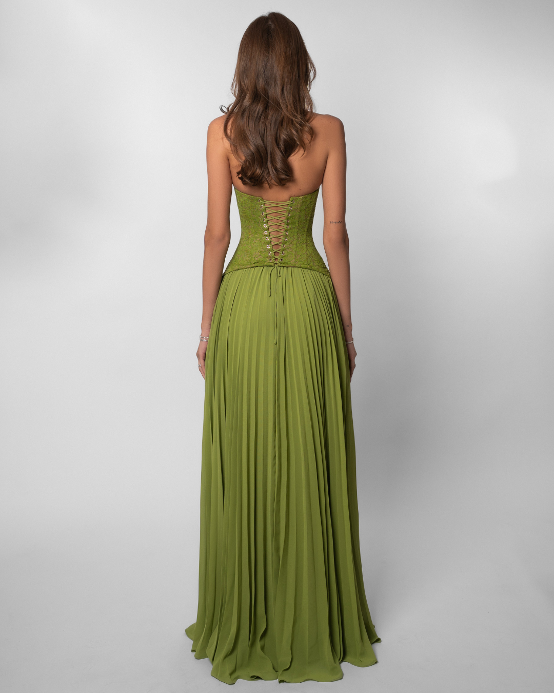 Olive green lace corset maxi dress with lace-up back, back view on model