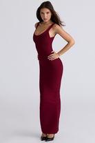 Ruby red bandage maxi dress, angled front view, hand on hip