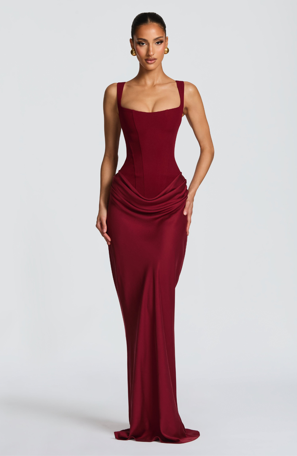 Burgundy corset-style maxi dress on model, front view