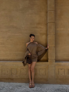 Taupe mini dress with draped batwing sleeve, front view on model