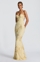 Lemon fitted maxi dress with gold floral embroidery, side view on model