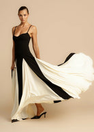 Black maxi dress with ivory skirt swirling, front view on model