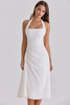 Ivory halter-neck midi dress with draped skirt, front view on model