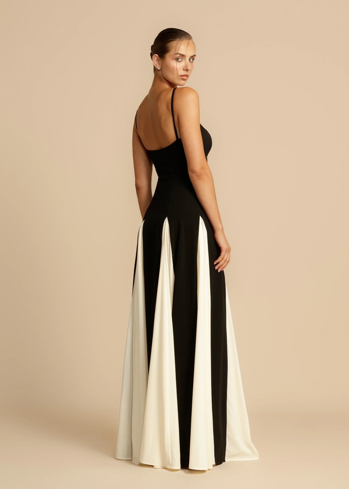 Black maxi dress with ivory godets, back and side view on model