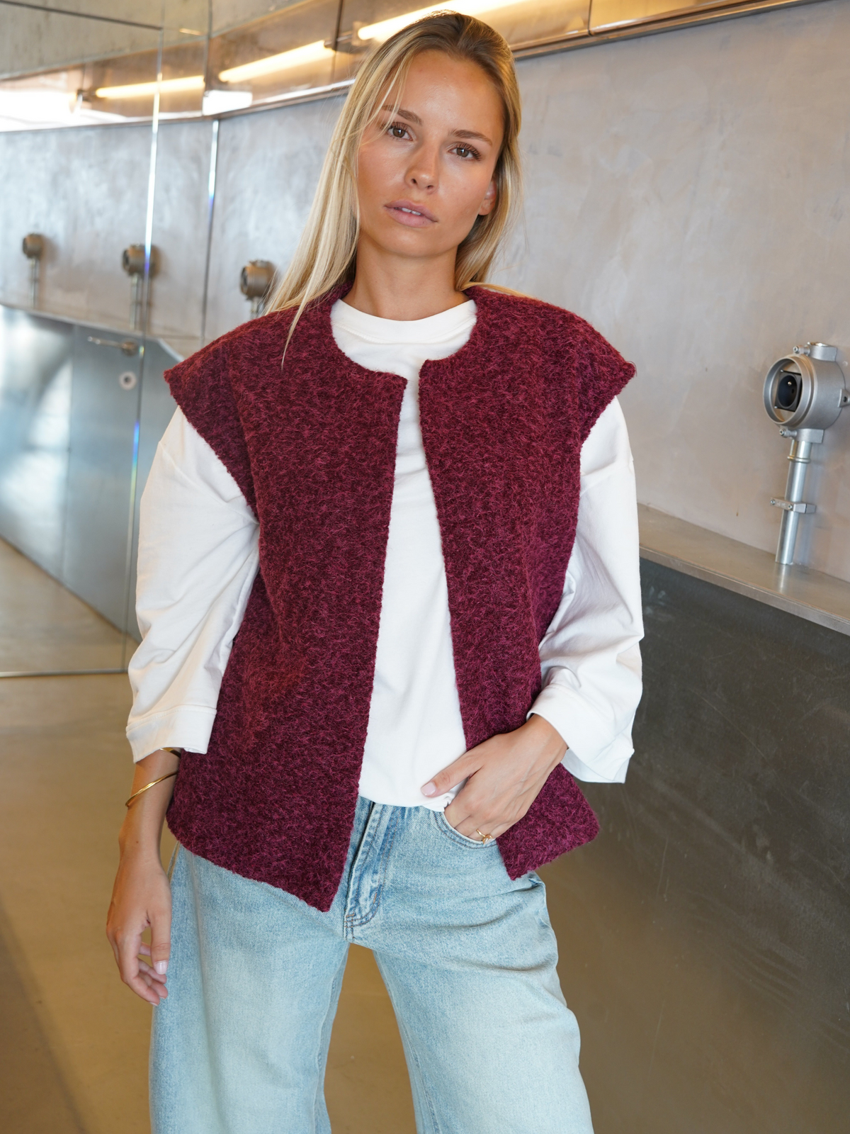 Burgundy bouclé knit vest over white top on model, front view