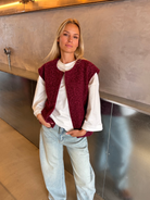 Burgundy bouclé knit vest on model, full length front view