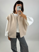 Beige bouclé knit vest with jeans, full mirror selfie on model