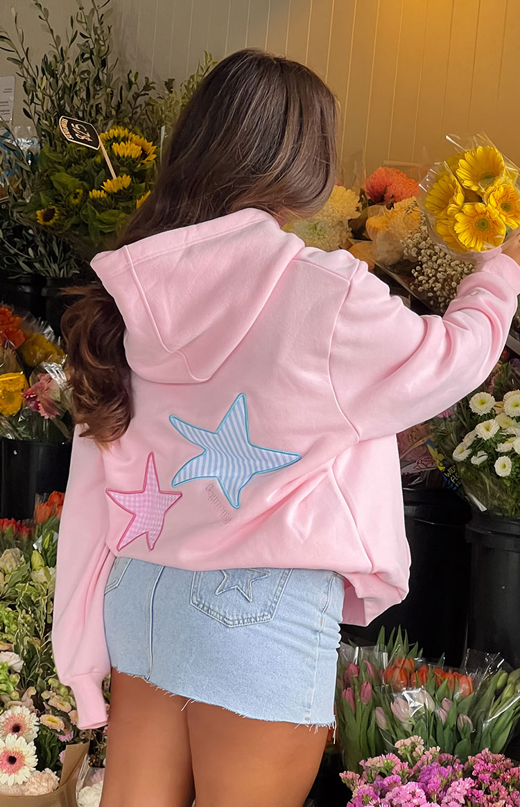 Pink hoodie with star patches, back view showing hood and applique