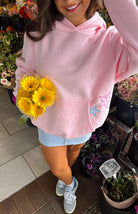 Pink hoodie with star patches, overhead view showing kangaroo pocket
