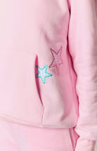 Close-up of pink hoodie pocket with gingham star patches