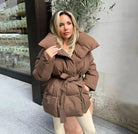 Brown belted puffer jacket, front view on model, street style