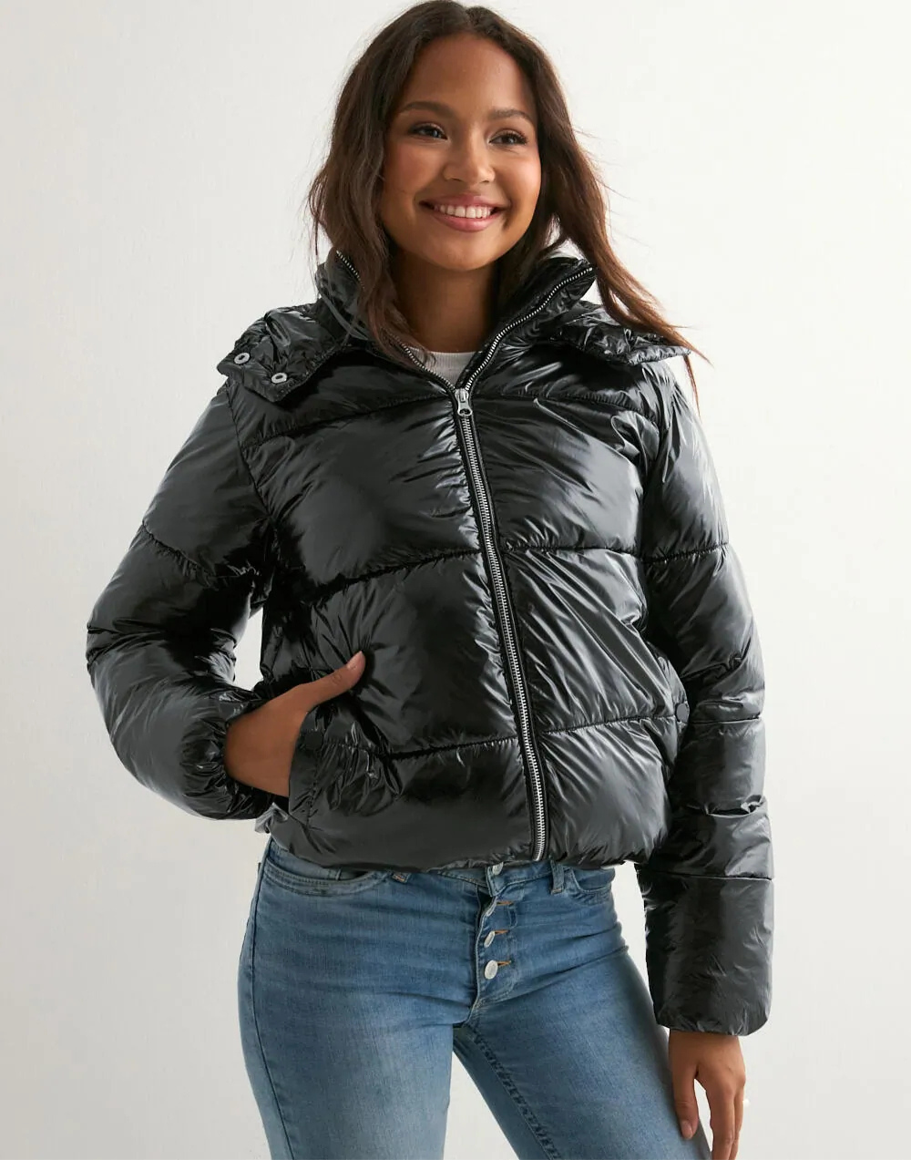 Black glossy hooded puffer jacket, front view with hand in pocket