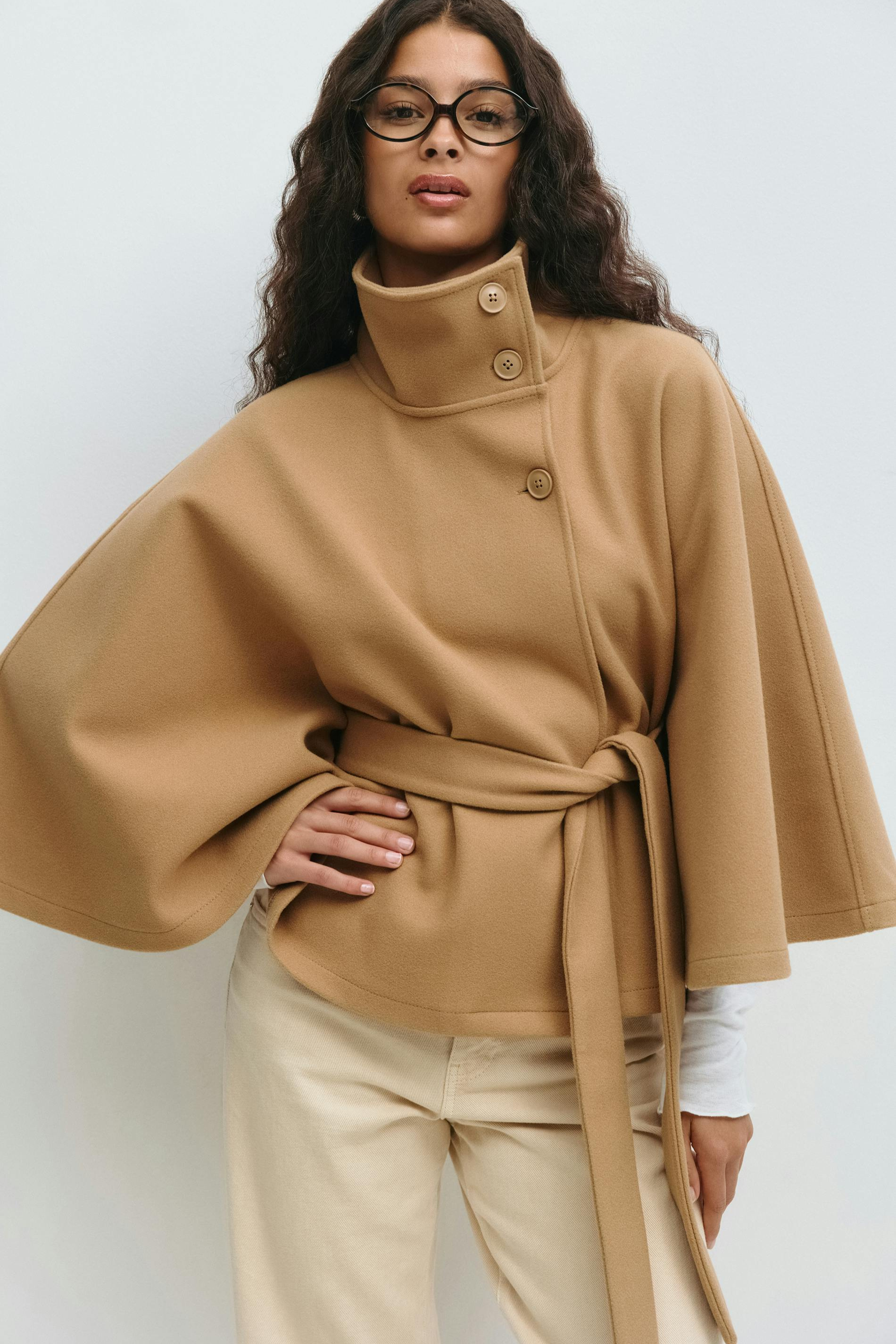 Beige belted cape jacket, close-up front view on model