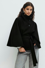 Black belted cape jacket, close-up front view on model