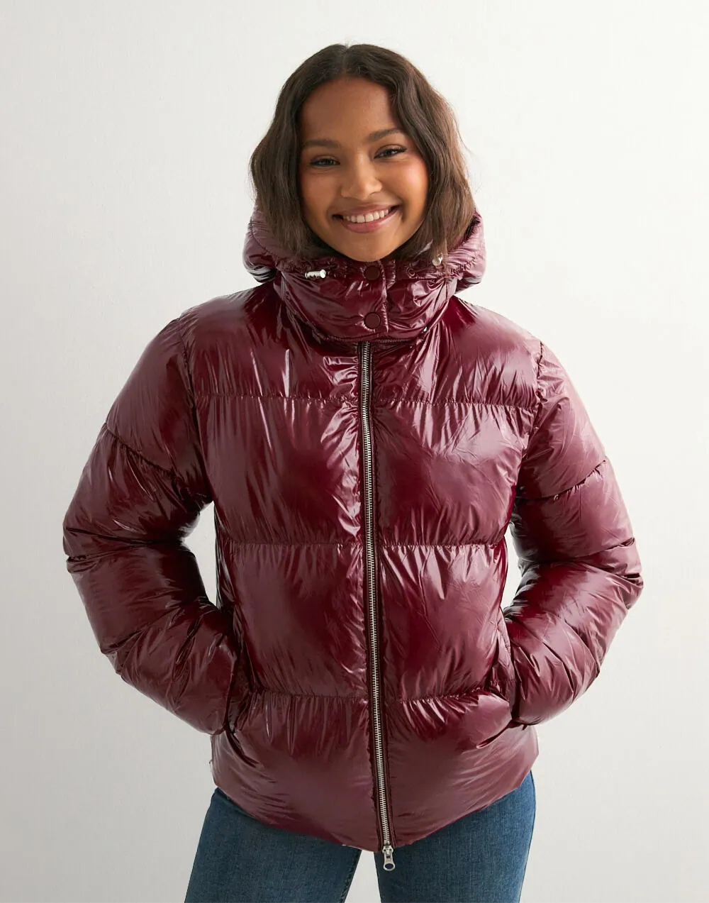 Wine red glossy hooded puffer jacket, hood up on model