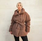 Brown belted puffer jacket, studio front view on model
