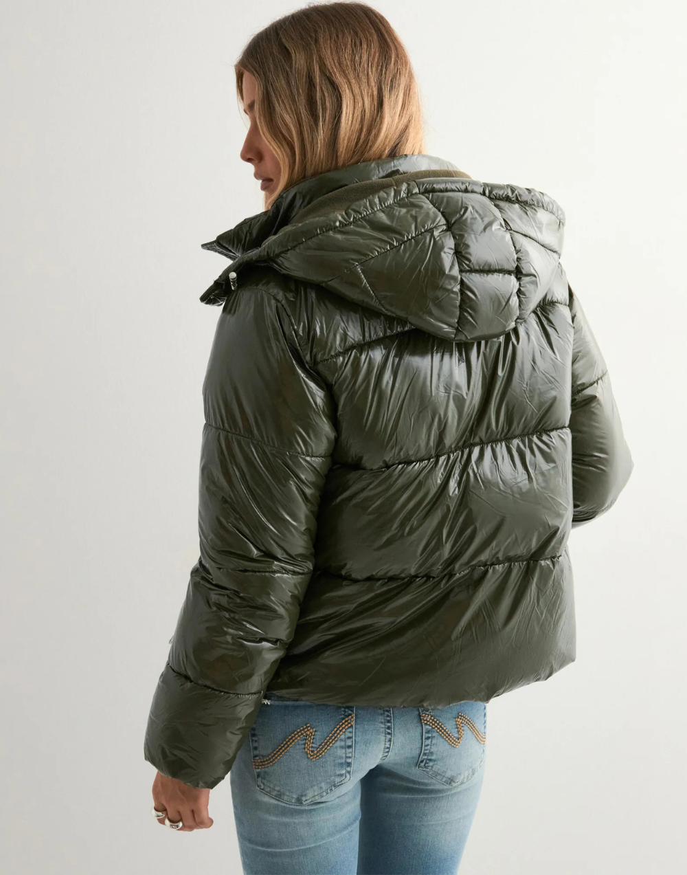 Green glossy hooded puffer jacket, back view on model