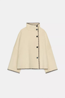 Cream wool jacket with contrast stitch edging, flat lay